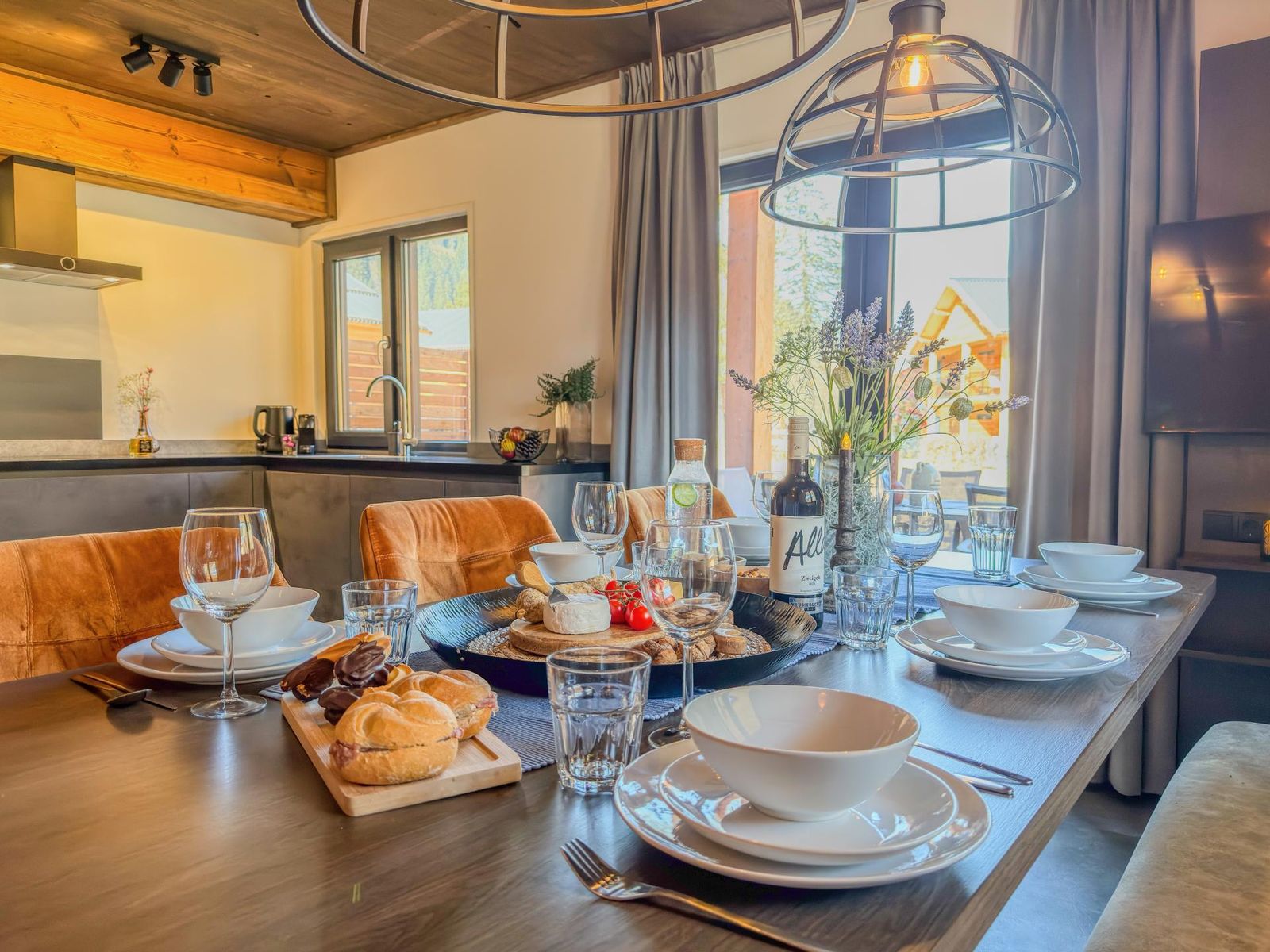 Dining table set for breakfast with the kitchen behind