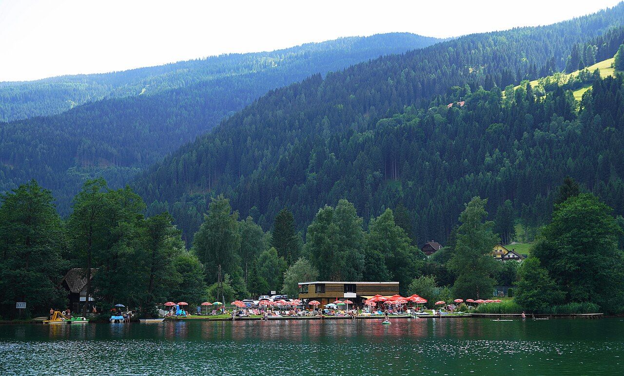 Public bathing area at the Afritzer See with swimmers and a grassy shore