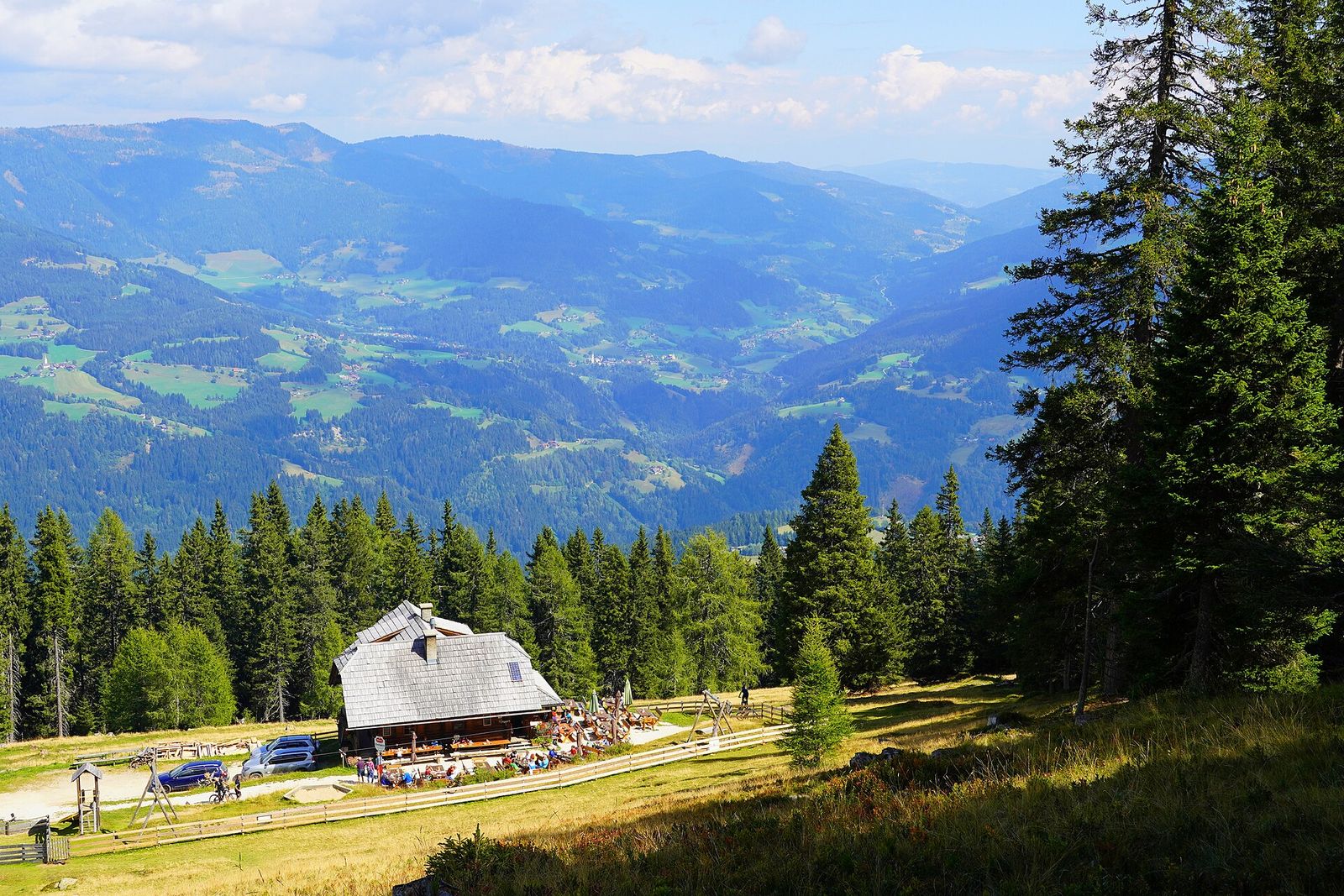 Alpine hut with shingled roof above the valley at Verditz in the Nockberge