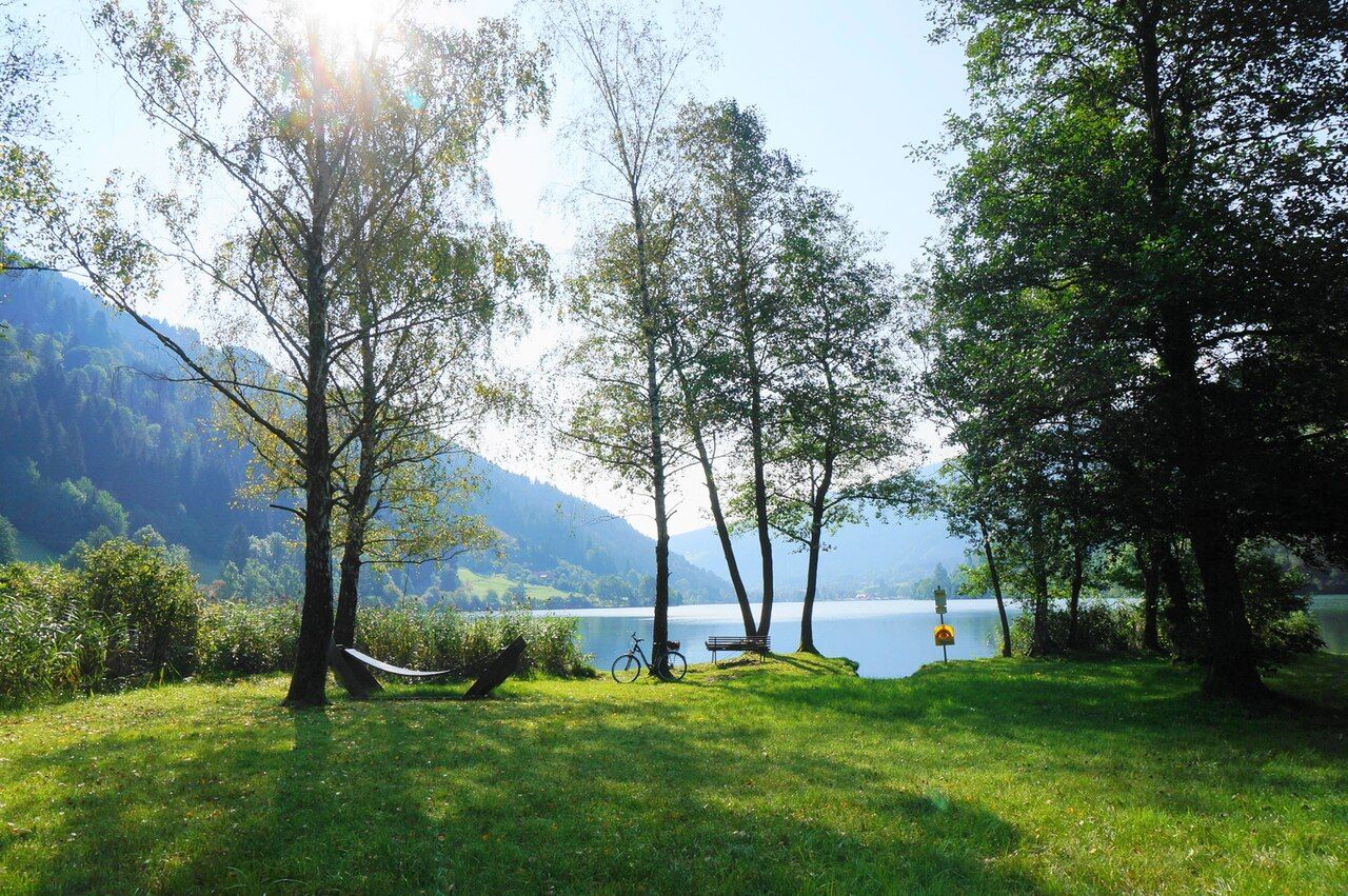 Lakeside lawn with hammock, bicycle and bench beside the Afritzer See